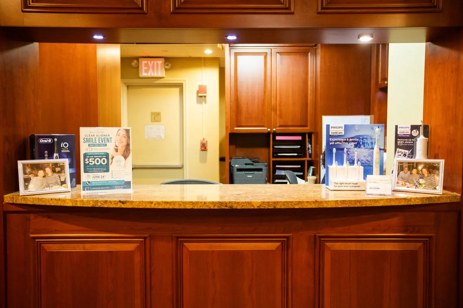 Front desk counter at Creative Dentistry of Brooklyn Heights with Oral-B and Philips Sonicare product displays