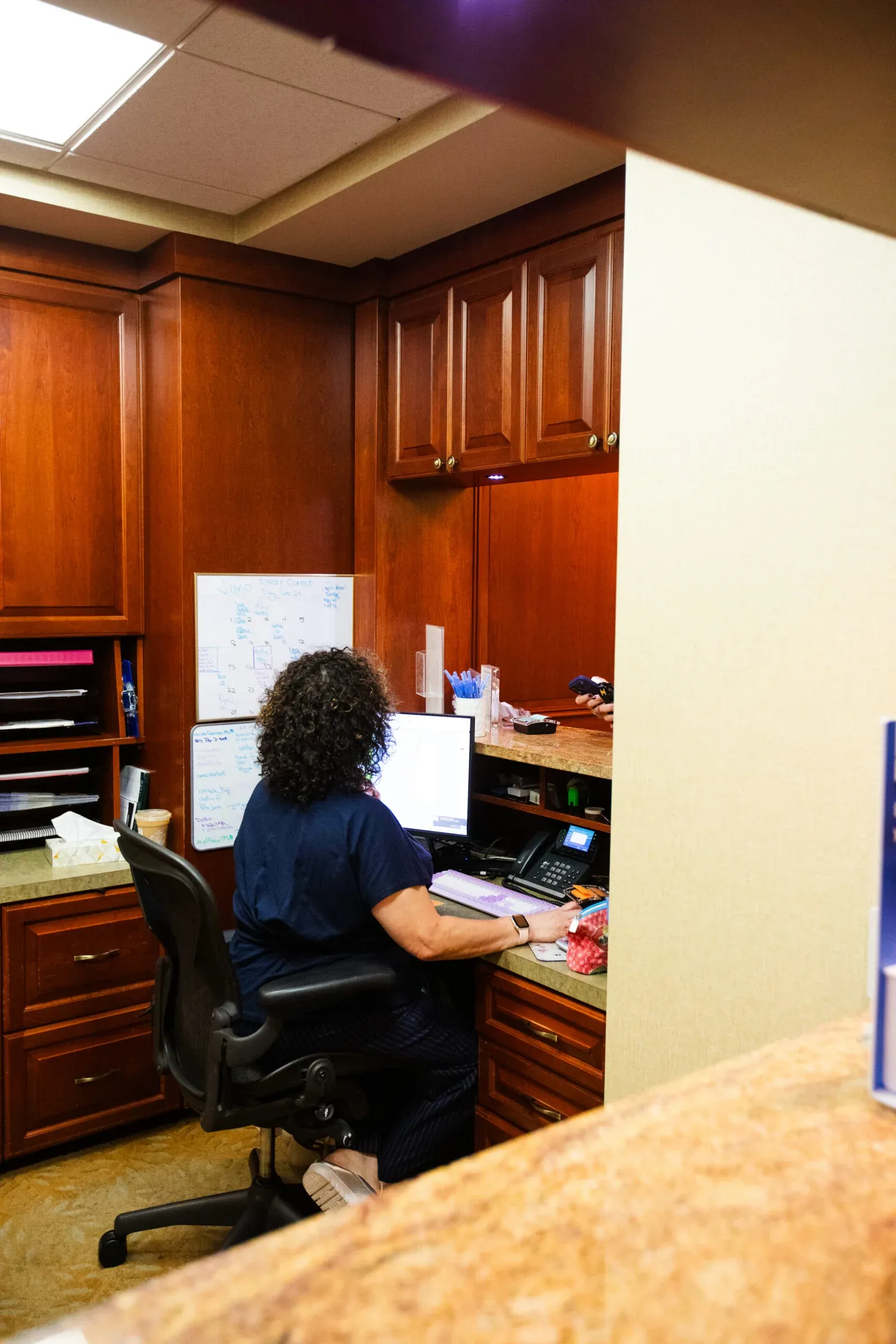 Front office staff member working at the desk at Creative Dentistry of Brooklyn Heights
