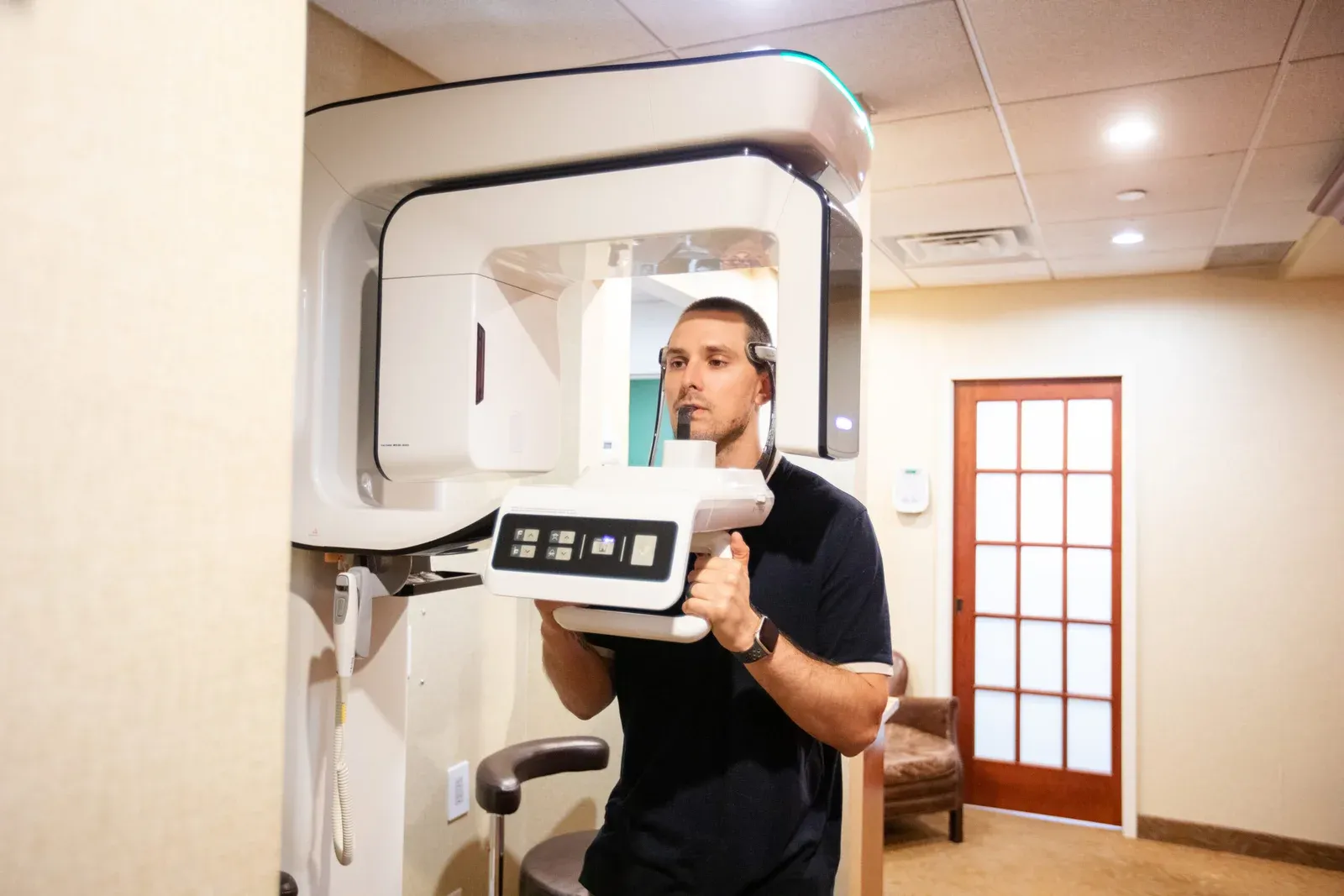 Patient undergoing a 3D CBCT dental scan at Creative Dentistry of Brooklyn Heights